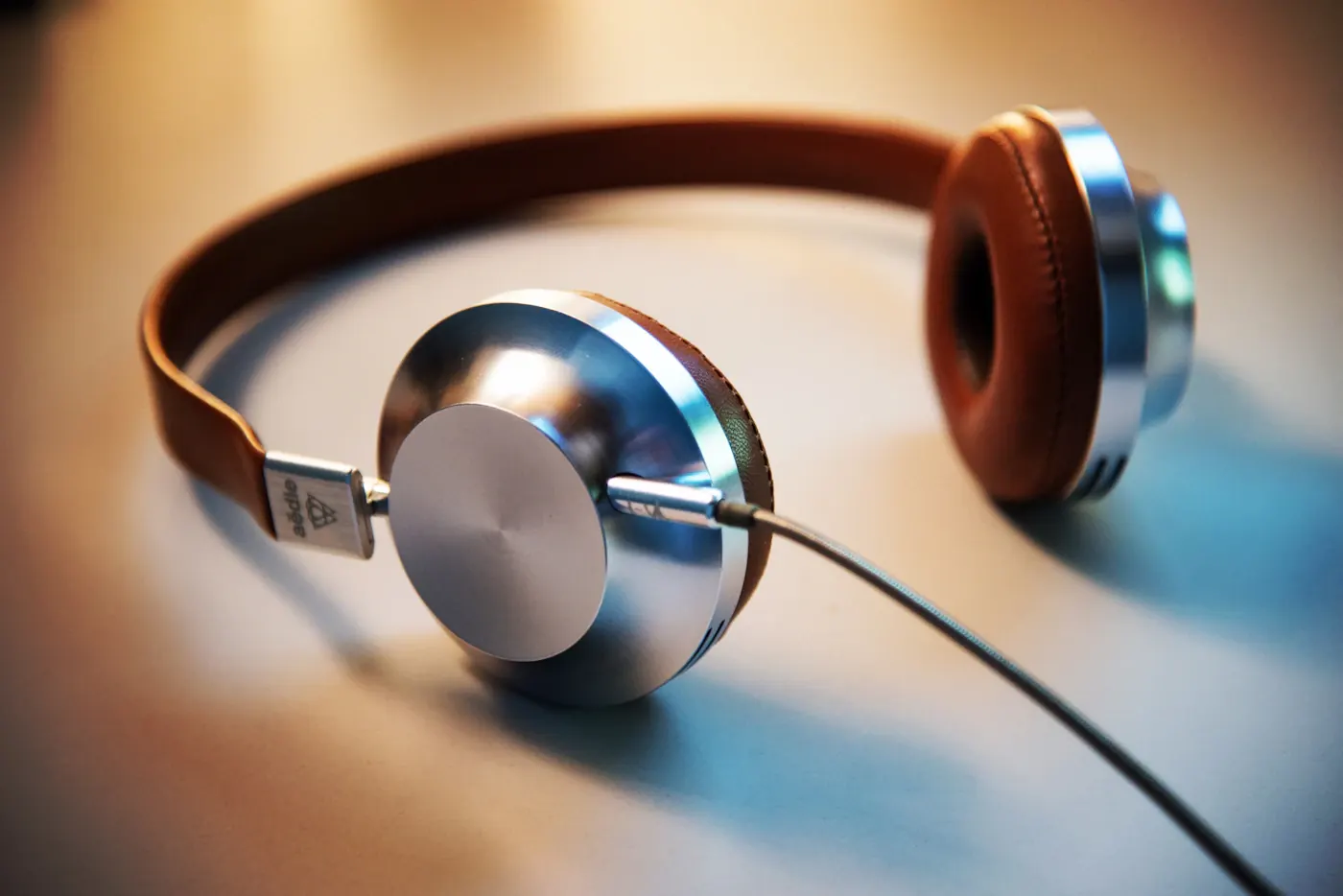 Over-ear headphones resting on a wooden surface